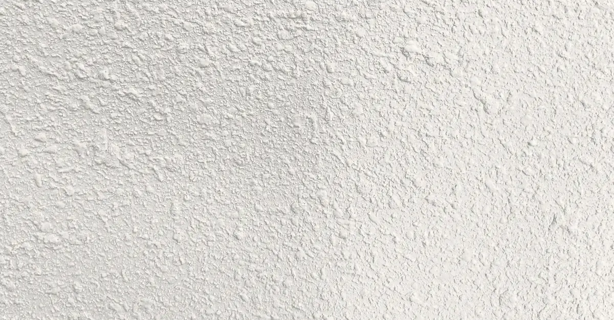 Close-up of orange peel drywall texture on a white wall