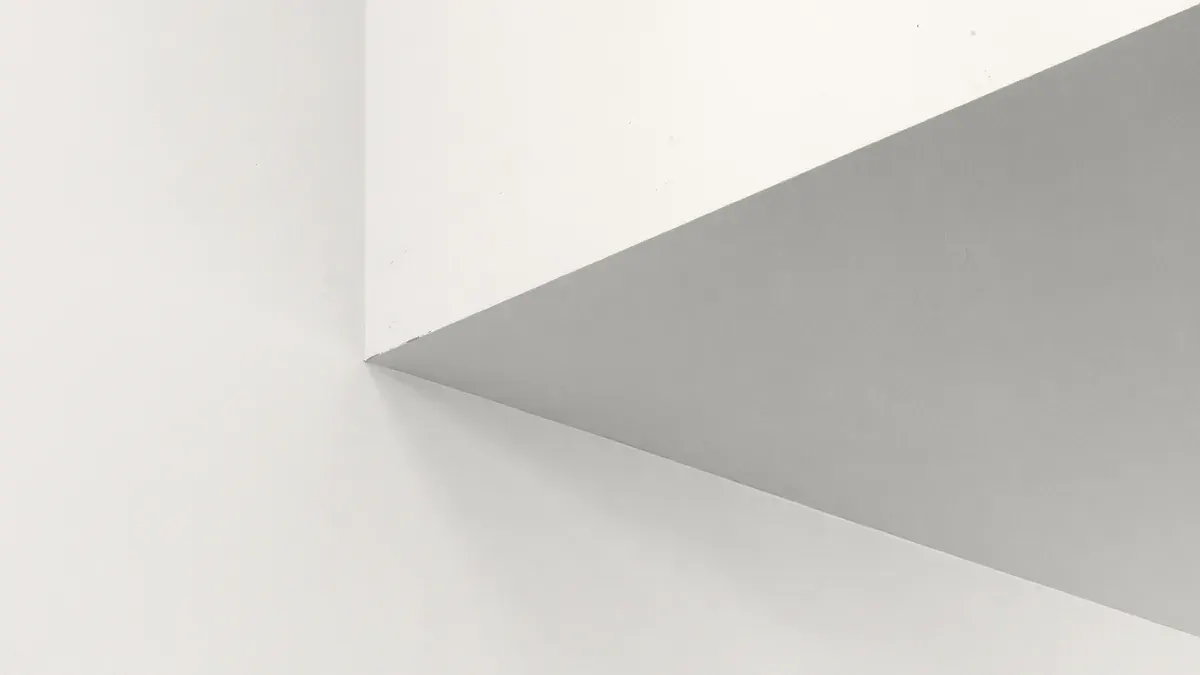 Smooth level 5 drywall walls and ceiling meeting at a corner
