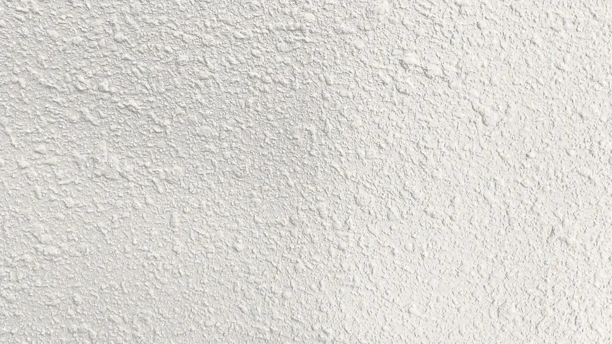 Close-up of orange peel drywall texture on a white wall