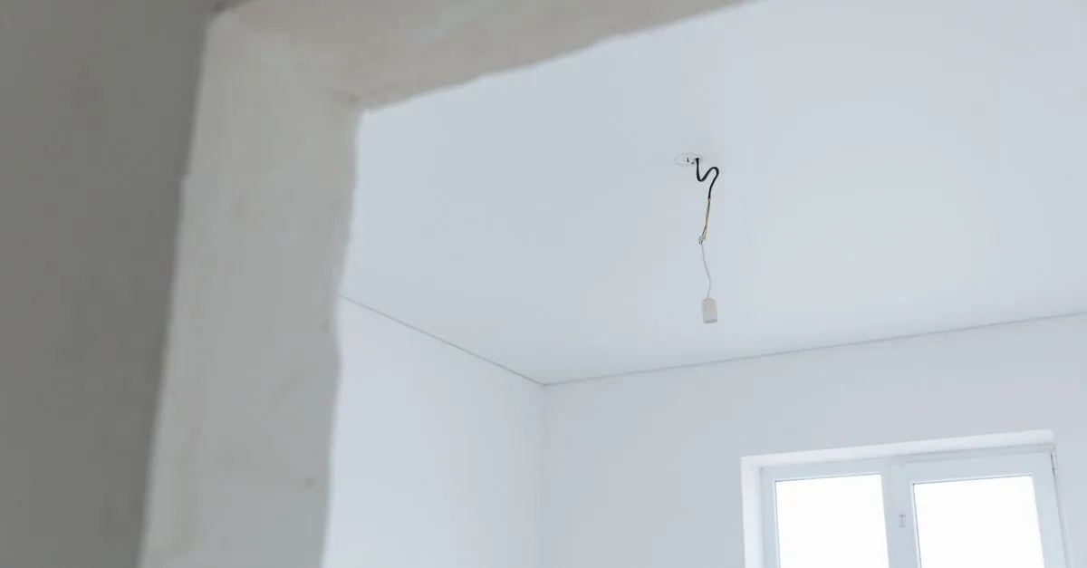 A residential ceiling and wall opened up to trace a water leak