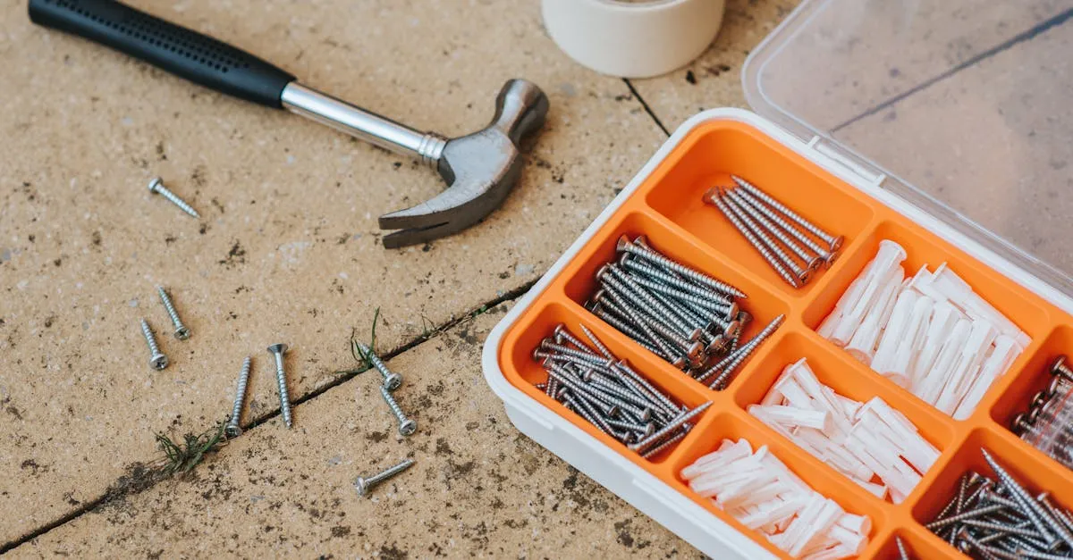 An assortment of home repair tools laid out for a drywall project