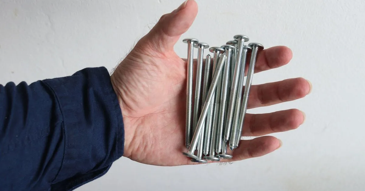 Drywall screws used to re-anchor a panel tight against the stud