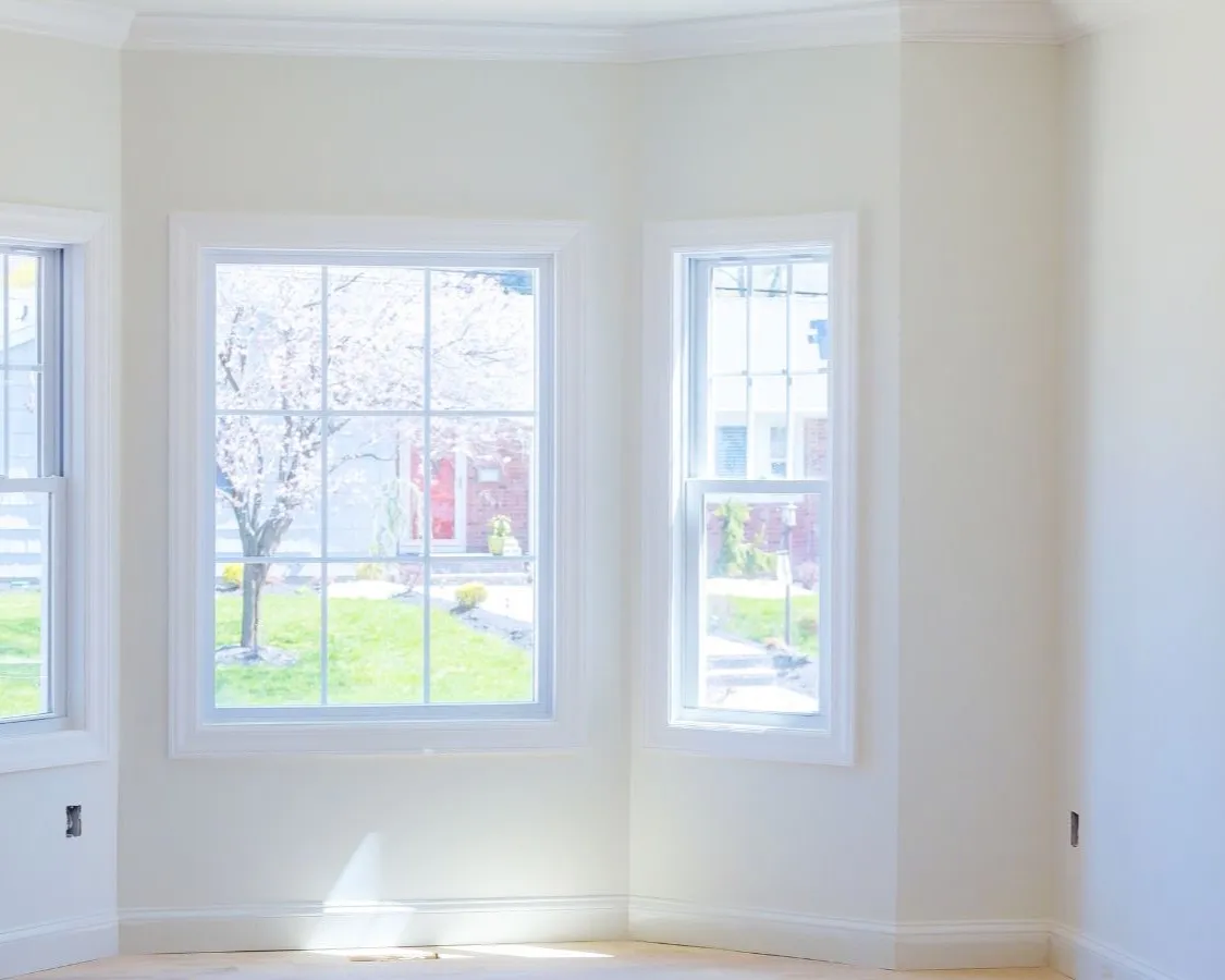 A finished room with smooth, paint-ready walls and a bay window